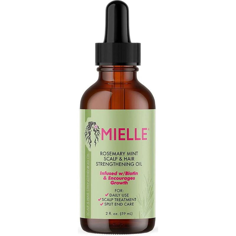 Mielle oil bottle with green label on a white background